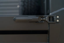 Close up of black over centre latch on a Rock Solid tray side